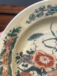 A Chinese famille verte caf&eacute;-au-lait ground plate and a monochrome white plate, Kangxi