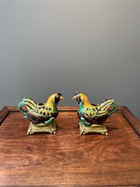 A pair of Chinese sancai-glazed chicken ewers mounted as candleholders with gilt bronze, Kangxi