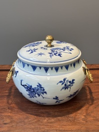 A Chinese blue and white covered bowl with floral design and gilt bronze mounts, Transitional period