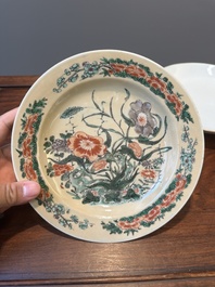 A Chinese famille verte caf&eacute;-au-lait ground plate and a monochrome white plate, Kangxi