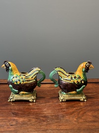 A pair of Chinese sancai-glazed chicken ewers mounted as candleholders with gilt bronze, Kangxi