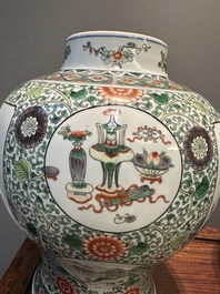A pair of Chinese famille verte 'bird and flower' vases and covers, Kangxi mark, 19th C.