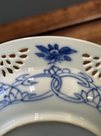 A Chinese blue and white reticulated double-walled cup and saucer, Kangxi