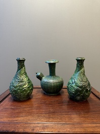 Two Chinese monochrome green-glazed stoneware 'dragon' vases and a kendi, Fujian kiln, late Ming