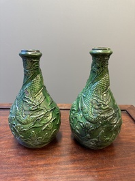 Two Chinese monochrome green-glazed stoneware 'dragon' vases and a kendi, Fujian kiln, late Ming