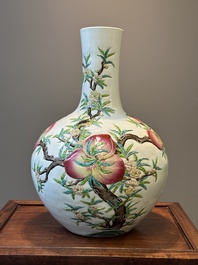 A Chinese famille rose relief-molded 'tianqiuping' vase with nine peaches, Qianlong mark, 19/20th C.