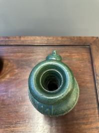 Two Chinese monochrome green-glazed stoneware 'dragon' vases and a kendi, Fujian kiln, late Ming