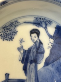 Four Chinese blue and white saucers and an 'erotic' cup, Kangxi