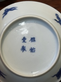 Four Chinese blue and white saucers and an 'erotic' cup, Kangxi