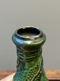 Two Chinese monochrome green-glazed stoneware 'dragon' vases and a kendi, Fujian kiln, late Ming