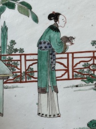 A rectangular Chinese famille verte plaque in a wooden faux bamboo frame, Kangxi