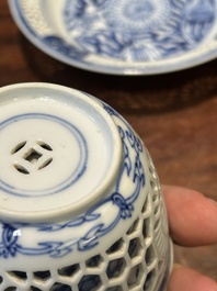 A Chinese blue and white reticulated double-walled cup and saucer, Kangxi
