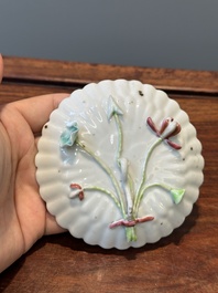 A Chinese famille rose relief-decorated cup and saucer, Yongzheng