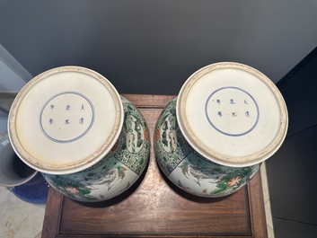 A pair of Chinese famille verte 'bird and flower' vases and covers, Kangxi mark, 19th C.