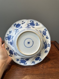 Four Chinese blue and white lobed 'phoenix and monkey' plates, flower mark, Kangxi