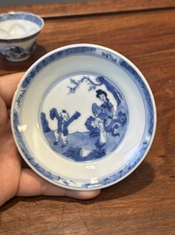 Four Chinese blue and white saucers and an 'erotic' cup, Kangxi