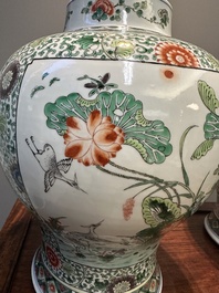 A pair of Chinese famille verte 'bird and flower' vases and covers, Kangxi mark, 19th C.