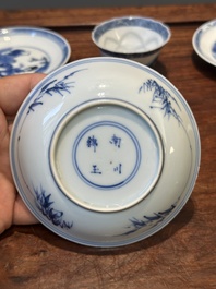 Four Chinese blue and white saucers and an 'erotic' cup, Kangxi