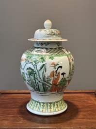 A Chinese famille verte covered vase and a bottle vase, 19th C.