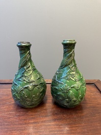 Two Chinese monochrome green-glazed stoneware 'dragon' vases and a kendi, Fujian kiln, late Ming