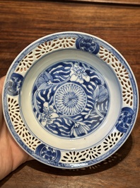 A Chinese blue and white reticulated double-walled cup and saucer, Kangxi