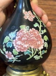 A pair of Chinese black-ground famille rose vases with gilt bronze mounts, Yongzheng