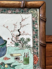 A rectangular Chinese famille verte plaque in a wooden faux bamboo frame, Kangxi