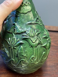 Two Chinese monochrome green-glazed stoneware 'dragon' vases and a kendi, Fujian kiln, late Ming