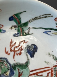 A Chinese famille verte 'qilin and falcon' plate, artemisia leaf mark, Kangxi