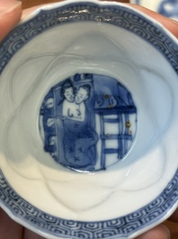 Four Chinese blue and white saucers and an 'erotic' cup, Kangxi