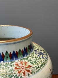 A Chinese wucai 'qilin' baluster vase, 19th C.