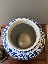 A Chinese blue and white 'lotus scroll' jar with wooden cover and stand, Kangxi