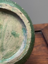 Two Chinese monochrome green-glazed stoneware 'dragon' vases and a kendi, Fujian kiln, late Ming
