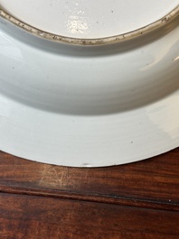 A Chinese blue and white dish with landscape and floral panels, Kangxi