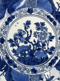 A Chinese blue and white dish with landscape and floral panels, Kangxi