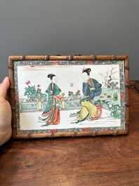 A rectangular Chinese famille verte plaque in a wooden faux bamboo frame, Kangxi