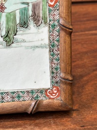 A rectangular Chinese famille verte plaque in a wooden faux bamboo frame, Kangxi