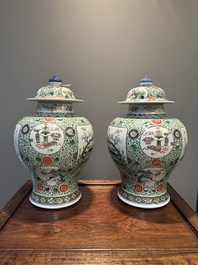 A pair of Chinese famille verte 'bird and flower' vases and covers, Kangxi mark, 19th C.