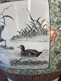 A Chinese famille verte covered vase and a bottle vase, 19th C.