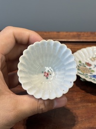A Chinese famille rose relief-decorated cup and saucer, Yongzheng