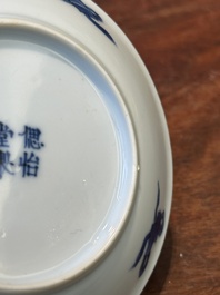 Four Chinese blue and white saucers and an 'erotic' cup, Kangxi