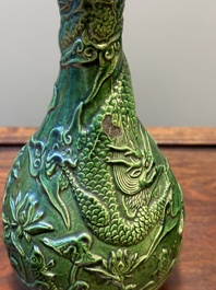 Two Chinese monochrome green-glazed stoneware 'dragon' vases and a kendi, Fujian kiln, late Ming