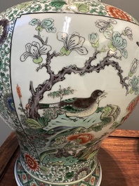 A pair of Chinese famille verte 'bird and flower' vases and covers, Kangxi mark, 19th C.