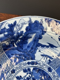 A Chinese blue and white dish with landscape and floral panels, Kangxi