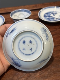Four Chinese blue and white saucers and an 'erotic' cup, Kangxi