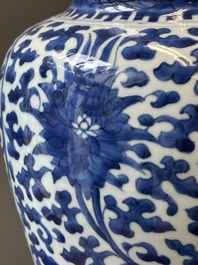 A Chinese blue and white 'lotus scroll' jar with wooden cover and stand, Kangxi