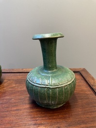 Two Chinese monochrome green-glazed stoneware 'dragon' vases and a kendi, Fujian kiln, late Ming
