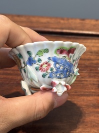 A Chinese famille rose relief-decorated cup and saucer, Yongzheng