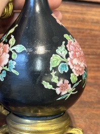 A pair of Chinese black-ground famille rose vases with gilt bronze mounts, Yongzheng