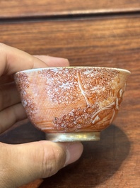 Two rare Chinese iron-red-decorated 'European scene' cups and a saucer, Qianlong